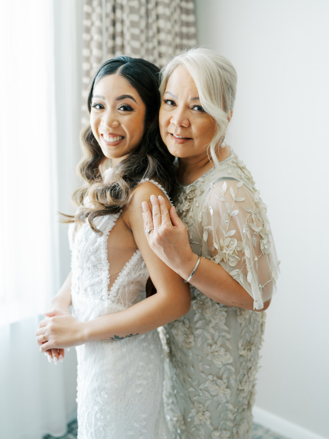 Mother of the bride embraces the bride during the getting ready period of the San Jose wedding at Signia by Hilton