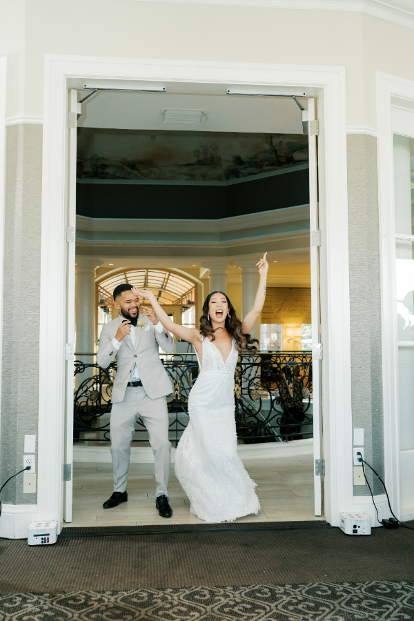 Bride and groom push open the doors and dance in during their San Jose wedding reception entrance as a new husband and wife