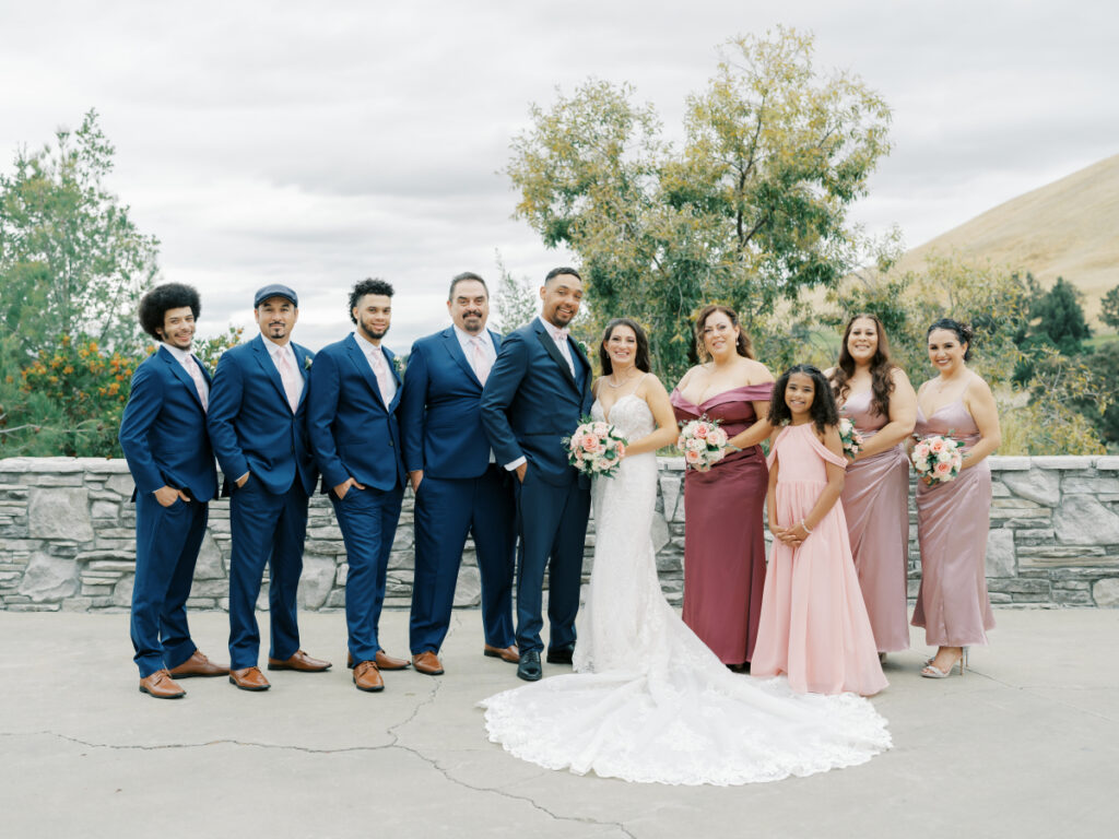 Bride and groom with groomsmen on left and bridesmaids on right at their San Francisco wedding venues.