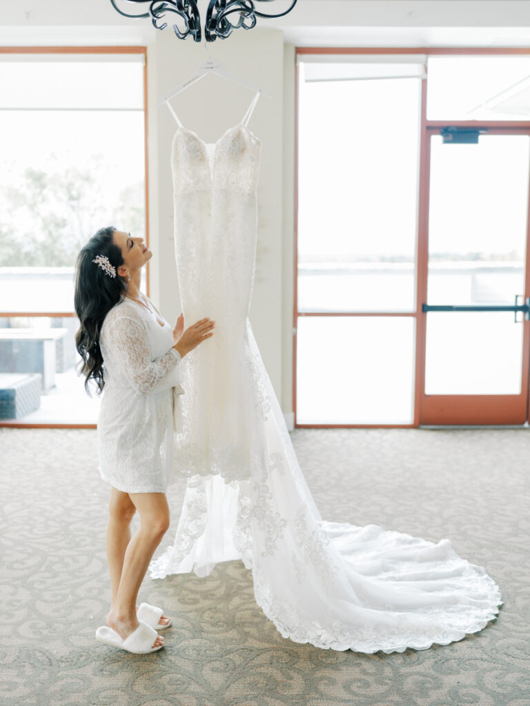 Bride looking at her wedding dress before putting it on at the bridal suite of the San Francisco wedding venues